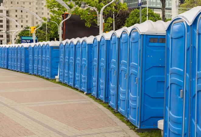 a row of portable restrooms set up for a large athletic event, allowing participants and spectators to easily take care of their needs in Philadelphia, TN